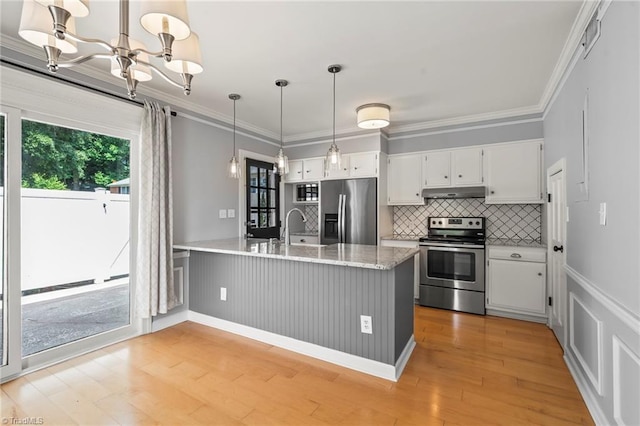 319 Hanover Arms Ct, Winston-Salem, NC 27104 - kitchen featuring appliances with stainless steel finishes, a peninsula, under cabinet range hood, white cabinets, and ornamental molding
