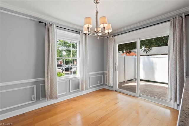 319 Hanover Arms Ct, Winston-Salem, NC 27104 - spare room featuring a chandelier, crown molding, wood finished floors, and wainscoting