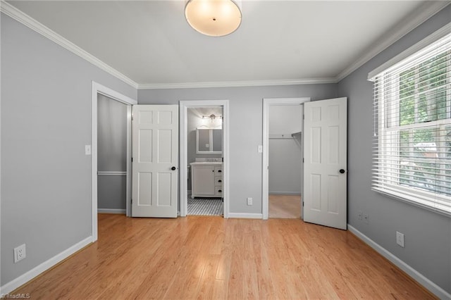 319 Hanover Arms Ct, Winston-Salem, NC 27104 - unfurnished bedroom with a spacious closet, a closet, light wood finished floors, crown molding, and baseboards