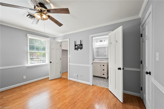 319 Hanover Arms Ct, Winston-Salem, NC 27104 - unfurnished bedroom featuring light wood-style floors, a walk in closet, a closet, baseboards, and crown molding