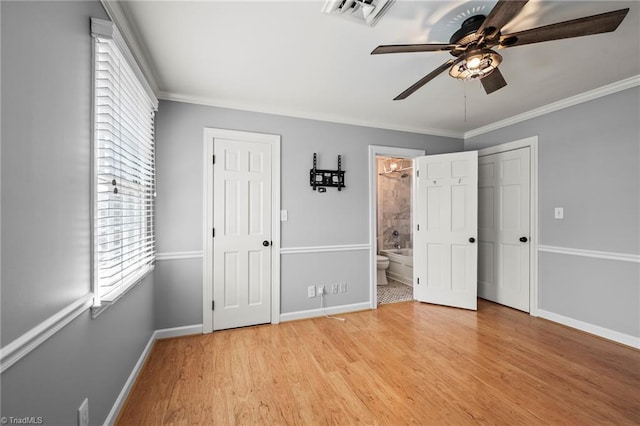 319 Hanover Arms Ct, Winston-Salem, NC 27104 - unfurnished bedroom with multiple windows, baseboards, light wood-type flooring, crown molding, and connected bathroom