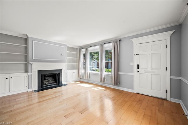 319 Hanover Arms Ct, Winston-Salem, NC 27104 - unfurnished living room with baseboards, light wood-style flooring, a fireplace with flush hearth, crown molding, and built in features