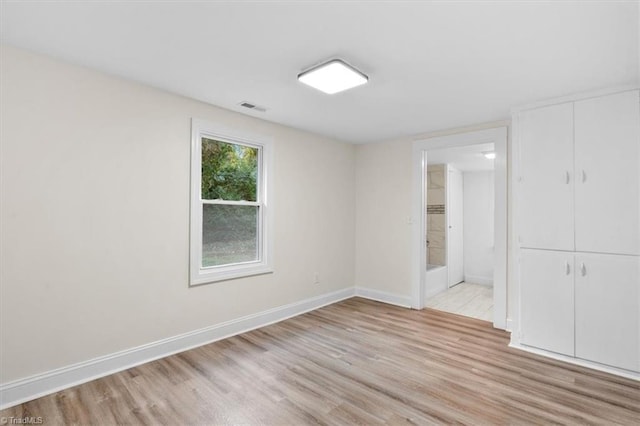 spare room featuring light hardwood / wood-style floors