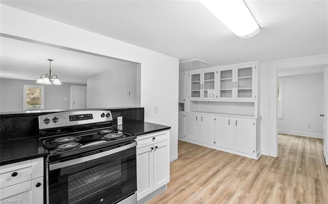 kitchen with a notable chandelier, white cabinets, light hardwood / wood-style floors, hanging light fixtures, and stainless steel electric range