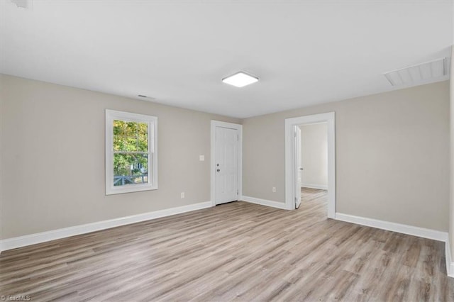 empty room with light hardwood / wood-style flooring