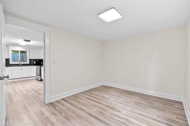 spare room featuring light wood-type flooring