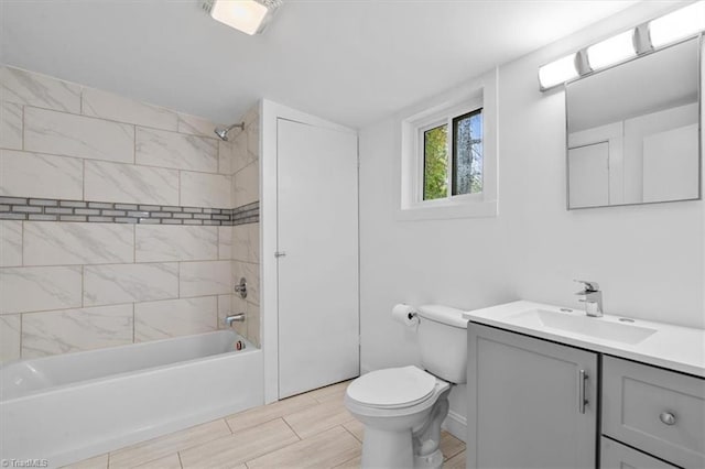 full bathroom featuring vanity, tiled shower / bath combo, and toilet