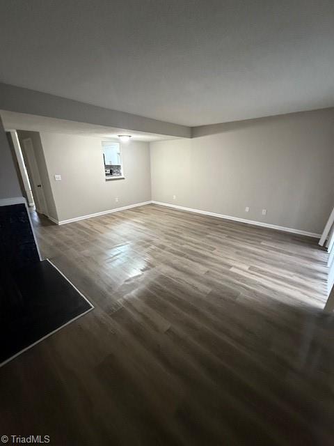 interior space featuring wood finished floors and baseboards