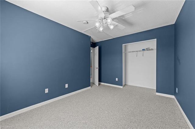 unfurnished bedroom with ceiling fan, a closet, and carpet floors