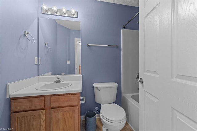 full bathroom with vanity,  shower combination, toilet, and a textured ceiling