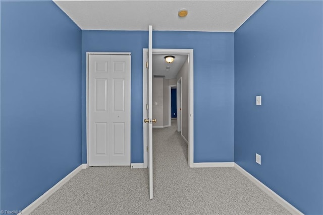 unfurnished bedroom with carpet flooring and a closet