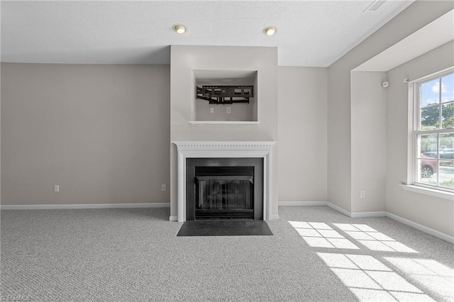 unfurnished living room with a healthy amount of sunlight and light carpet