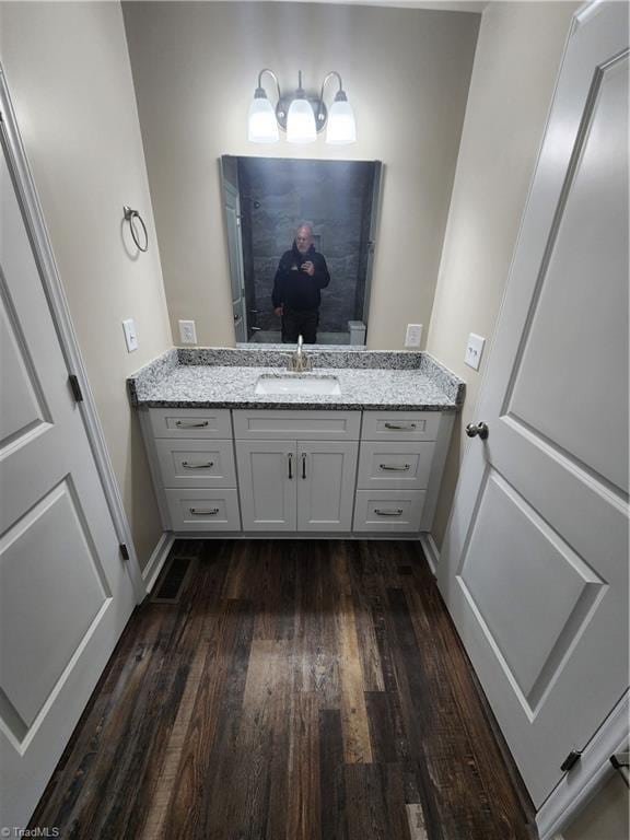 bathroom with hardwood / wood-style floors and vanity