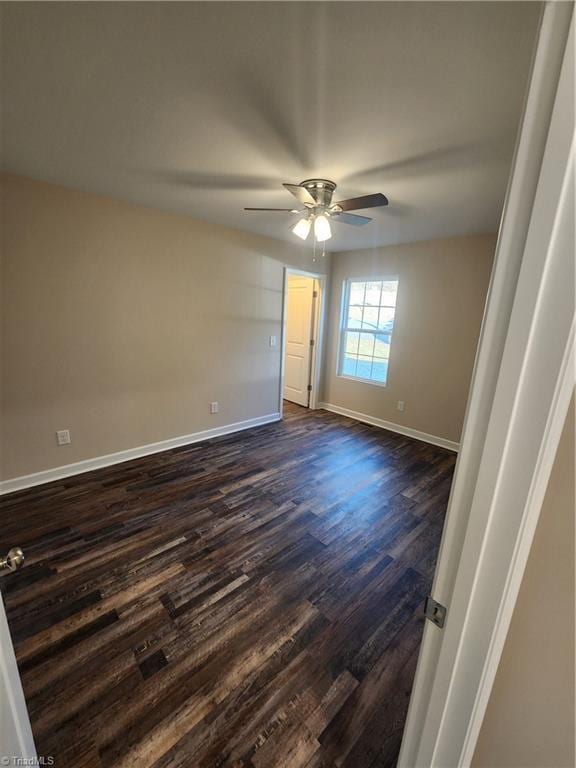 unfurnished room featuring ceiling fan and dark hardwood / wood-style floors