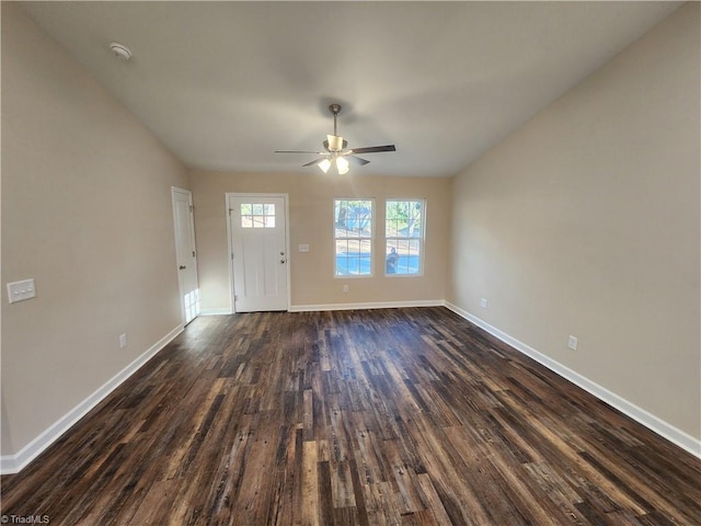 interior space with ceiling fan and dark hardwood / wood-style flooring