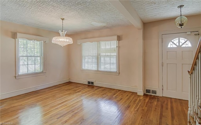 1900 Peachtree St, Winston-Salem, NC 27107 - foyer entrance with a chandelier, wood finished floors, plenty of natural light, and a textured ceiling