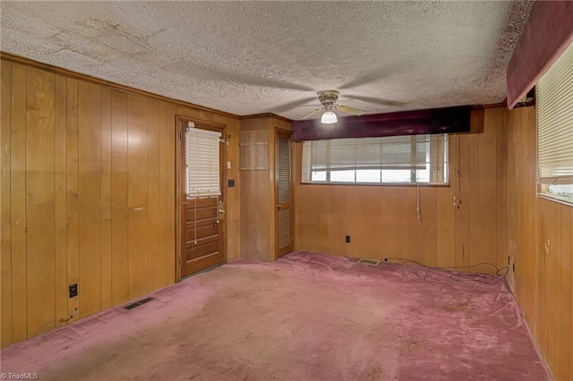 1900 Peachtree St, Winston-Salem, NC 27107 - carpeted spare room featuring wooden walls, a ceiling fan, and a textured ceiling