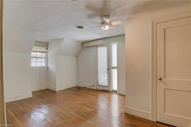 1900 Peachtree St, Winston-Salem, NC 27107 - additional living space with a textured ceiling, wood-type flooring, vaulted ceiling, baseboards, and a ceiling fan