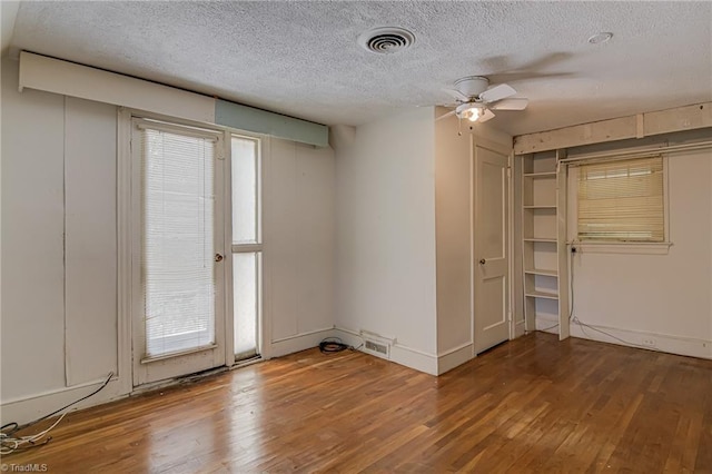 1900 Peachtree St, Winston-Salem, NC 27107 - empty room featuring hardwood / wood-style flooring, plenty of natural light, a textured ceiling, and a ceiling fan