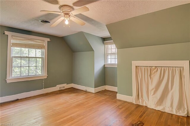 1900 Peachtree St, Winston-Salem, NC 27107 - bonus room featuring a textured ceiling, wood finished floors, lofted ceiling, baseboards, and a ceiling fan