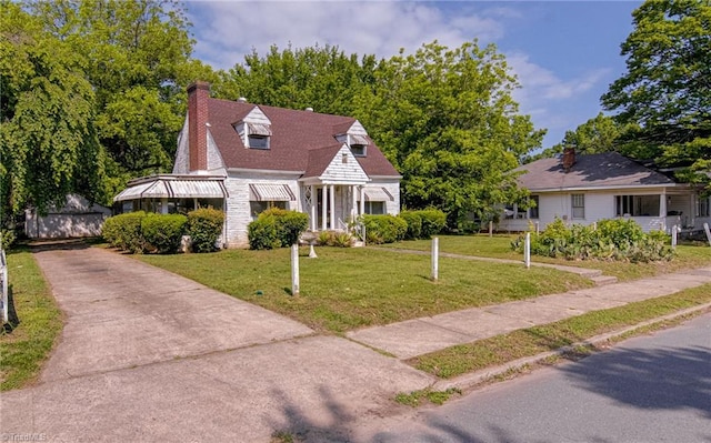 1900 Peachtree St, Winston-Salem, NC 27107 - new england style home with a front yard, an outbuilding, and a chimney