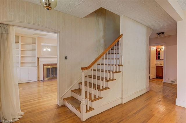 1900 Peachtree St, Winston-Salem, NC 27107 - staircase featuring wood finished floors and a fireplace