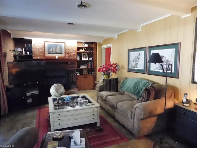 living room with ornamental molding, built in features, and beamed ceiling