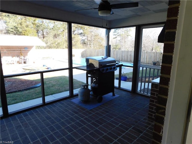 sunroom featuring ceiling fan