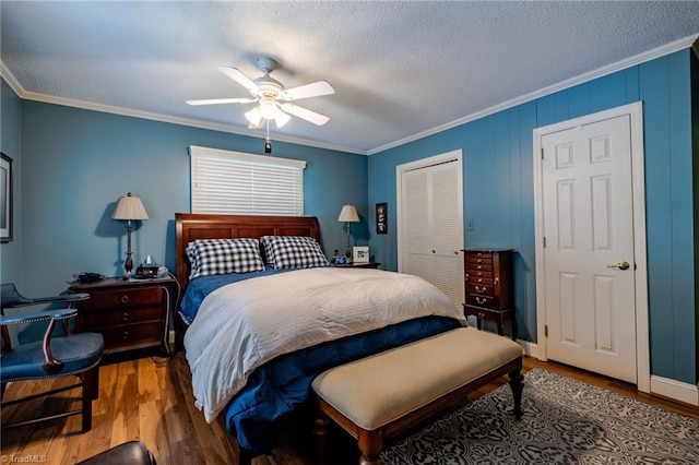 bedroom with hardwood / wood-style flooring, ornamental molding, a closet, and a textured ceiling