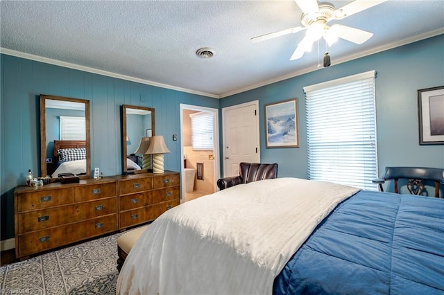 bedroom featuring ceiling fan, crown molding, ensuite bath, and a textured ceiling