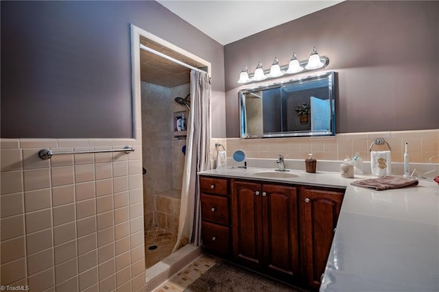 bathroom featuring tile walls, vanity, and curtained shower