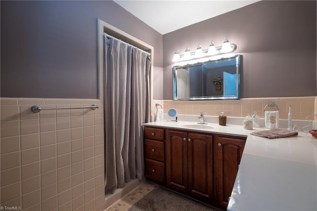 bathroom featuring vanity and tile walls