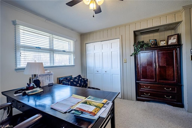 office space with wooden walls, ornamental molding, and ceiling fan