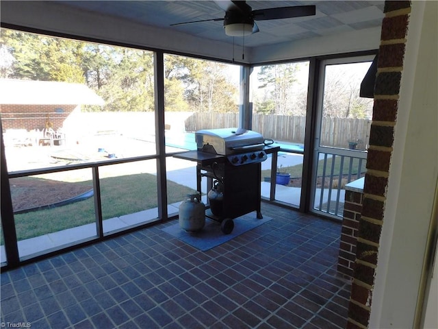 sunroom / solarium with ceiling fan