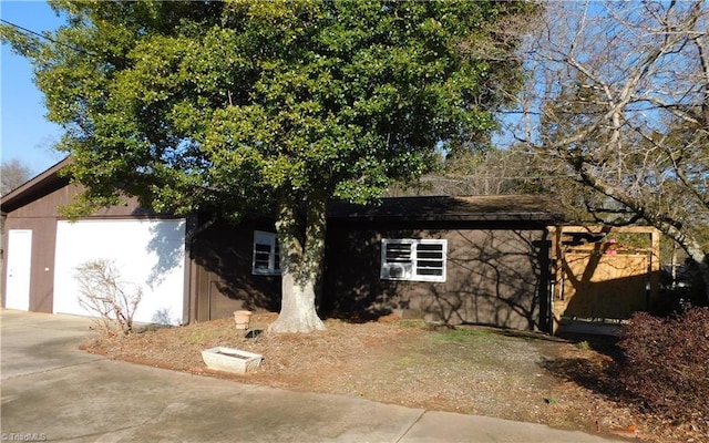 view of side of home featuring a garage