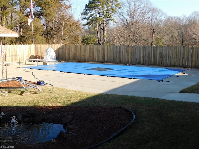 view of pool with a yard and a patio