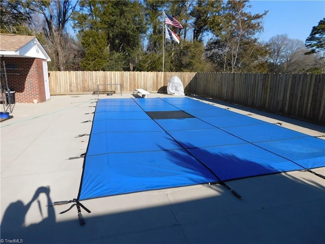 view of pool with a diving board