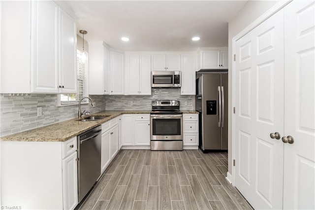 3027 Kinnamon Rd, Winston-Salem, NC 27104 - kitchen featuring stainless steel appliances, a sink, white cabinetry, and recessed lighting
