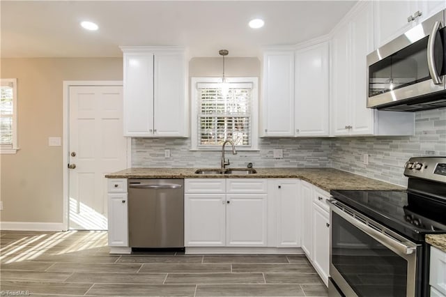 3027 Kinnamon Rd, Winston-Salem, NC 27104 - kitchen with stainless steel appliances, a sink, baseboards, backsplash, and plenty of natural light