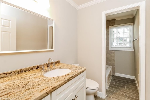 3027 Kinnamon Rd, Winston-Salem, NC 27104 - full bath with toilet, crown molding, vanity, wood finished floors, and baseboards