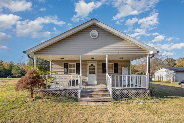 bungalow-style house with a front lawn and covered porch