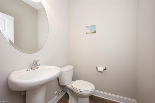 410 Mountain Grove Ln, Kernersville, NC 27284 - bathroom with toilet, baseboards, wood finished floors, and a sink