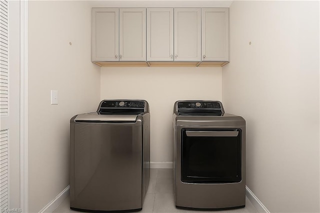 410 Mountain Grove Ln, Kernersville, NC 27284 - laundry area with independent washer and dryer, cabinet space, baseboards, and light tile patterned floors