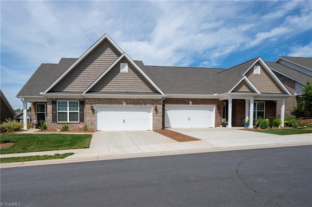 410 Mountain Grove Ln, Kernersville, NC 27284 - craftsman house featuring driveway, brick siding, an attached garage, and a front lawn