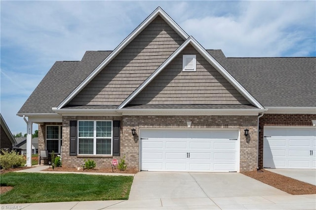 410 Mountain Grove Ln, Kernersville, NC 27284 - craftsman inspired home featuring brick siding, driveway, a front lawn, and a shingled roof