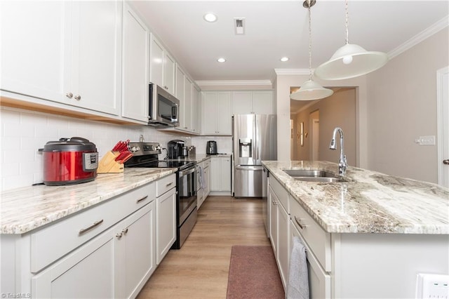 410 Mountain Grove Ln, Kernersville, NC 27284 - kitchen with stainless steel appliances, a sink, crown molding, tasteful backsplash, and light wood-type flooring