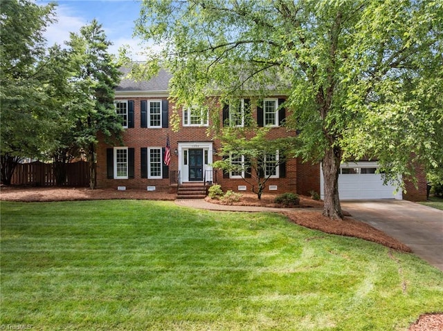 1203 Westminster Dr, Greensboro, NC 27410 - colonial house with driveway, a garage, and brick siding