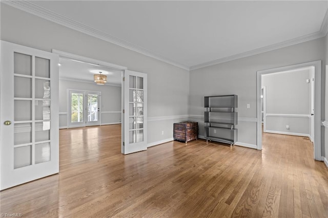 1203 Westminster Dr, Greensboro, NC 27410 - unfurnished living room with french doors, crown molding, and wood finished floors