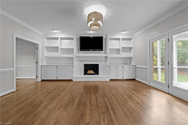1203 Westminster Dr, Greensboro, NC 27410 - unfurnished living room with crown molding, dark wood-style floors, a fireplace with raised hearth, and built in features