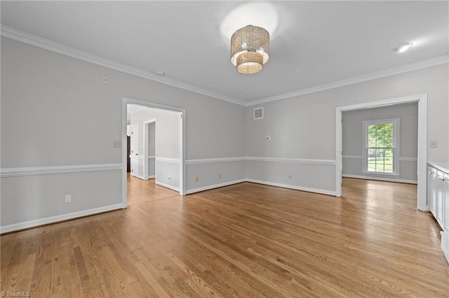1203 Westminster Dr, Greensboro, NC 27410 - empty room featuring ornamental molding and light wood finished floors